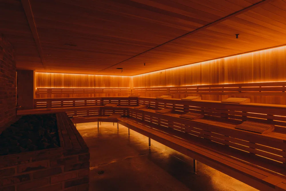 The cedar sauna at JOY, lit in warm amber