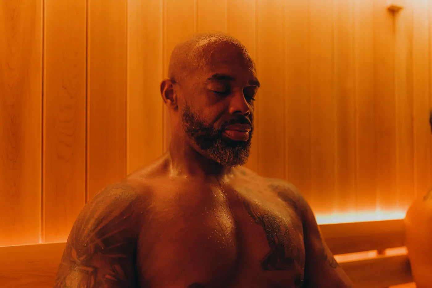 A guest resting in the sauna with his eyes closed, calm